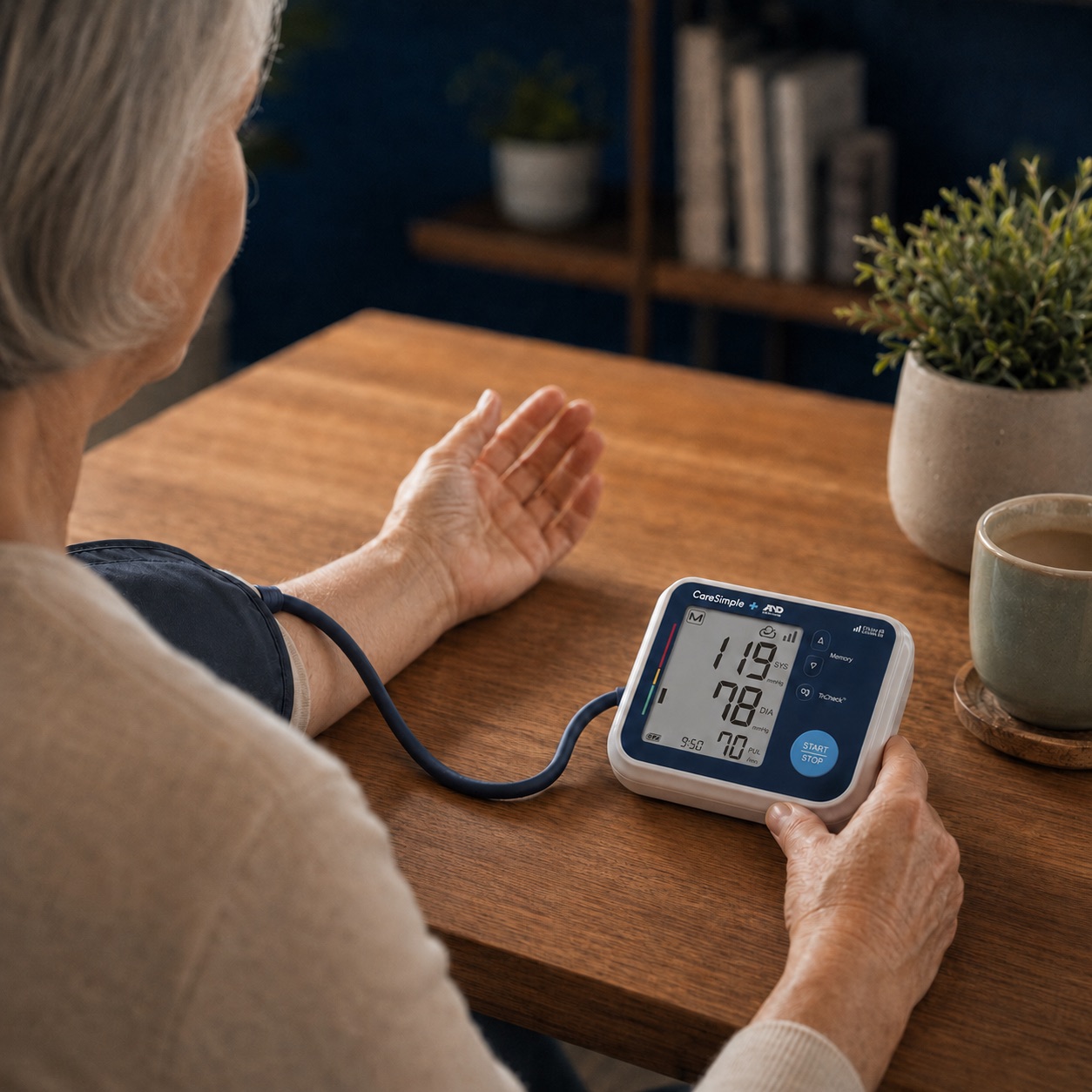 Older patient at home taking a reading on a CareSimple cellular blood pressure monitor